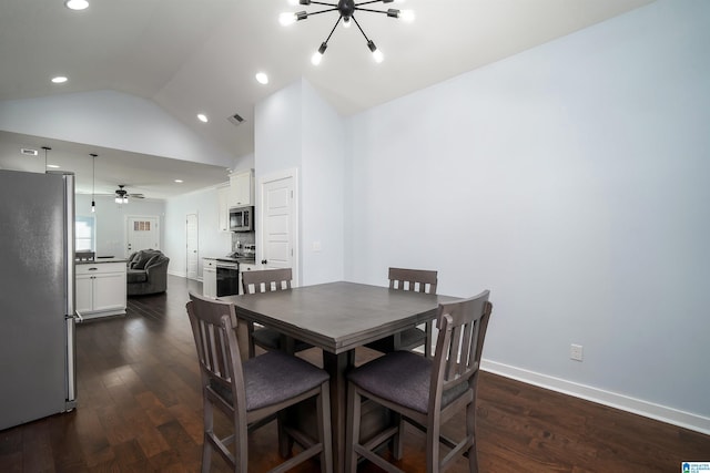 dining room featuring ceiling fan with notable chandelier, lofted ceiling, and dark wood-type flooring