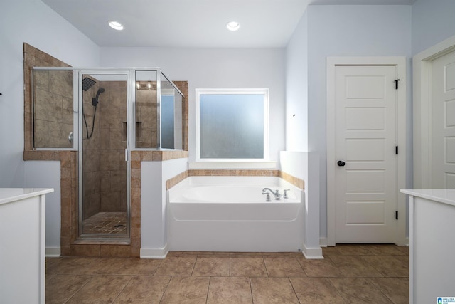 bathroom with shower with separate bathtub and tile patterned floors