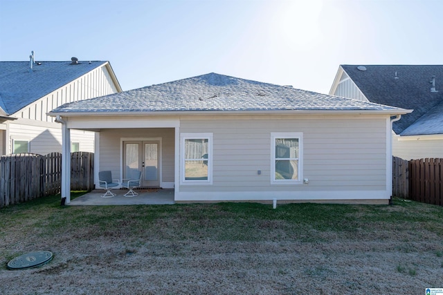 rear view of property with a lawn and a patio