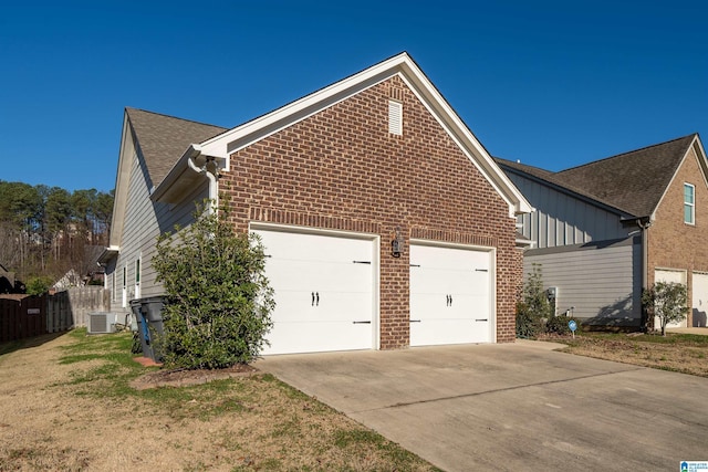 view of home's exterior with cooling unit and a garage