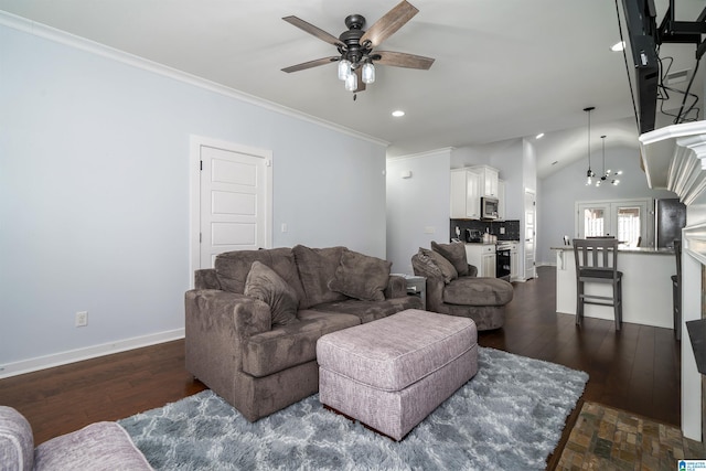 living room with ceiling fan with notable chandelier, dark hardwood / wood-style floors, lofted ceiling, and crown molding