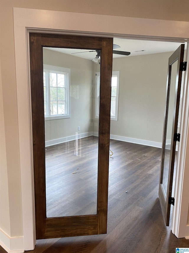 spare room featuring dark hardwood / wood-style floors and ceiling fan