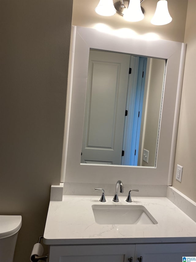 bathroom featuring vanity and toilet