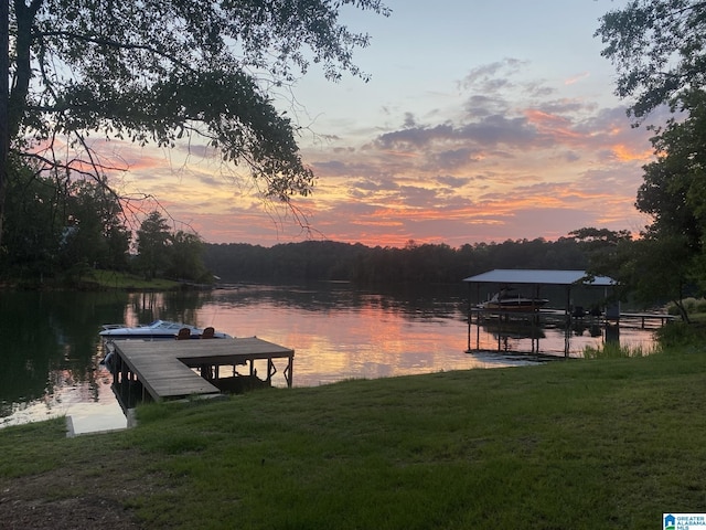 dock area with a water view and a yard