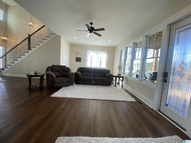 living room featuring dark hardwood / wood-style flooring and ceiling fan