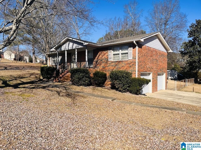 ranch-style home with a porch and a garage