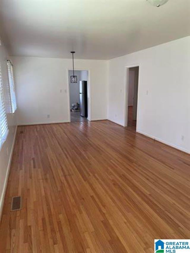 unfurnished living room featuring hardwood / wood-style flooring