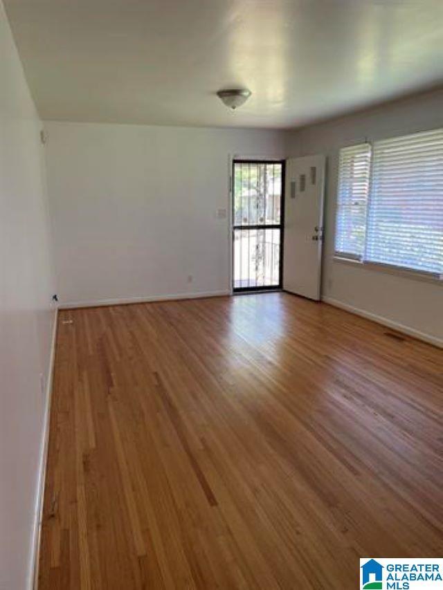 unfurnished room featuring hardwood / wood-style floors