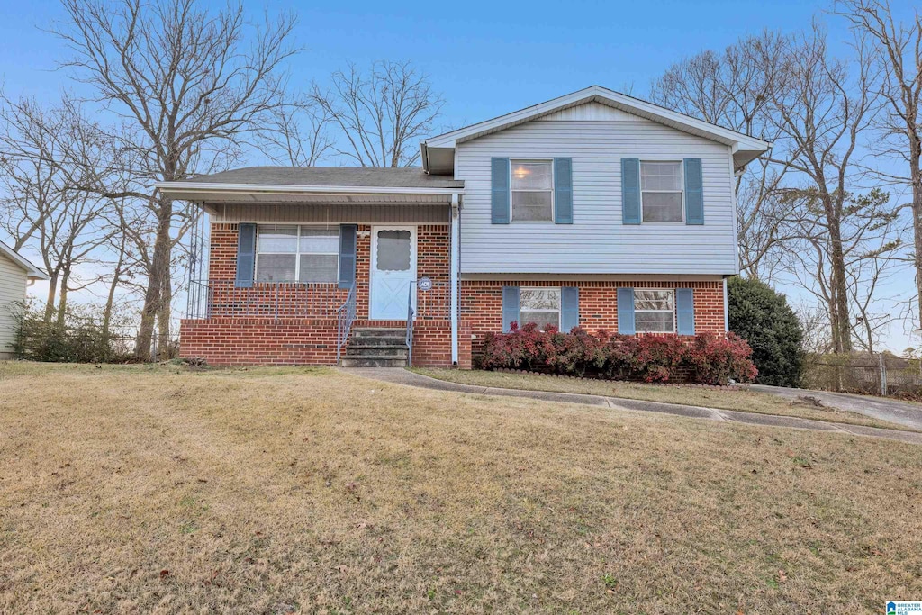 split level home featuring a front lawn