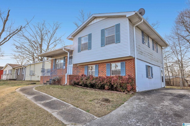 tri-level home with a porch and a front lawn