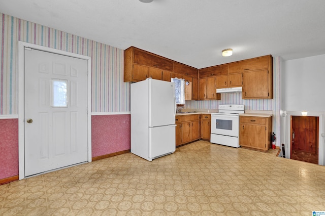 kitchen with a textured ceiling, sink, and white appliances