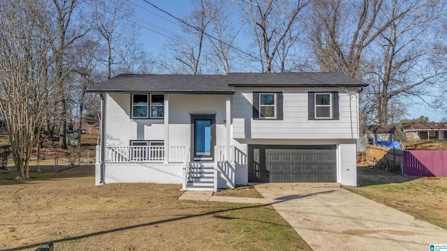 split foyer home featuring a front yard and a garage