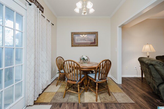 dining space with dark hardwood / wood-style floors, crown molding, and a notable chandelier