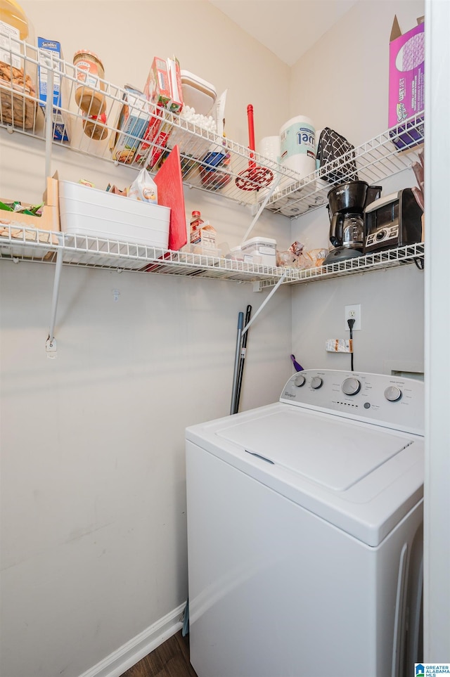 washroom featuring dark hardwood / wood-style flooring and washer / clothes dryer