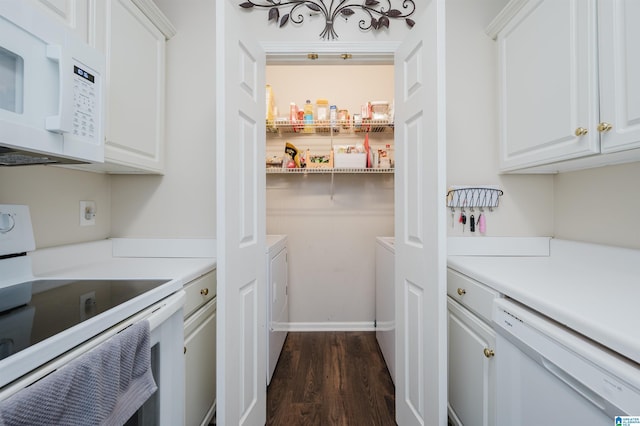 kitchen featuring white appliances, dark hardwood / wood-style floors, white cabinetry, and washer and clothes dryer