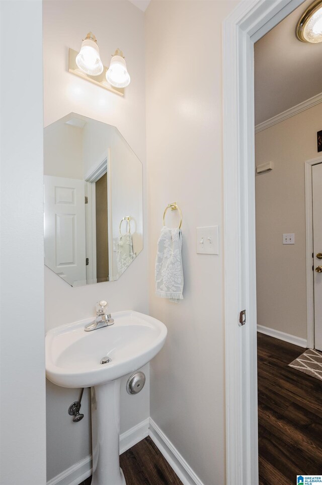 bathroom featuring hardwood / wood-style floors and crown molding