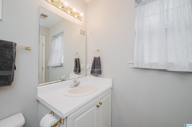 bathroom featuring vanity and toilet