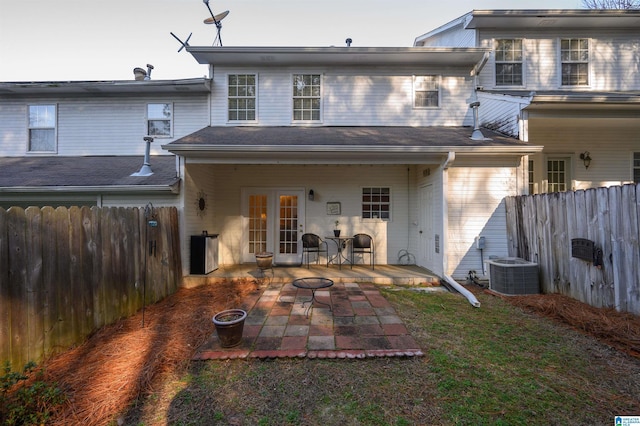 back of house featuring a yard, cooling unit, and a patio area