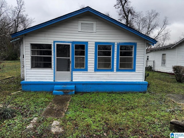 view of side of home with a yard