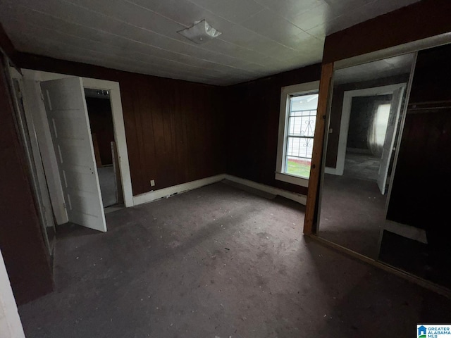 unfurnished bedroom with wood walls