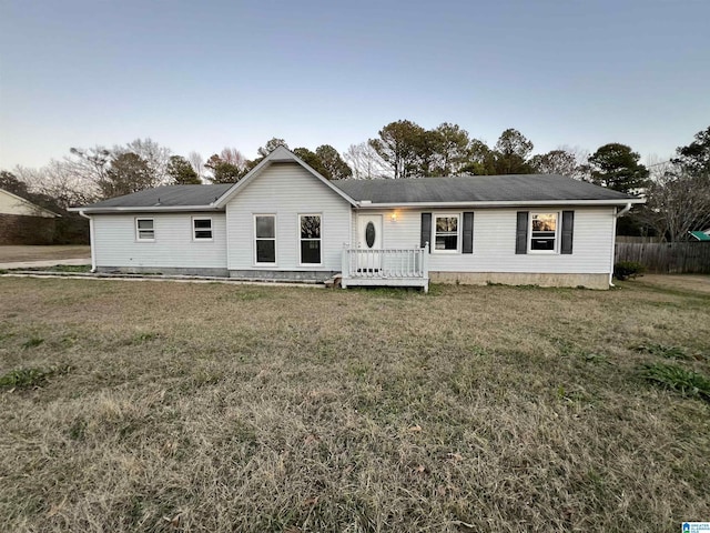 view of front of property featuring a deck and a front lawn