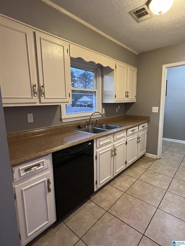 kitchen with a textured ceiling, sink, black dishwasher, white cabinetry, and light tile patterned flooring