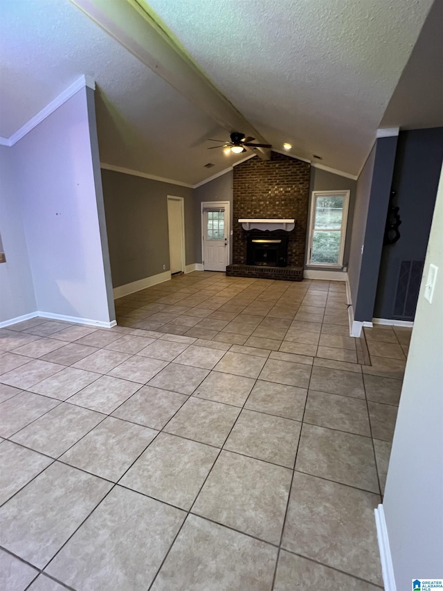 unfurnished living room with a textured ceiling, ceiling fan, a fireplace, lofted ceiling, and light tile patterned flooring