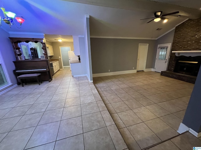 tiled living room featuring ceiling fan with notable chandelier, a brick fireplace, lofted ceiling, and crown molding