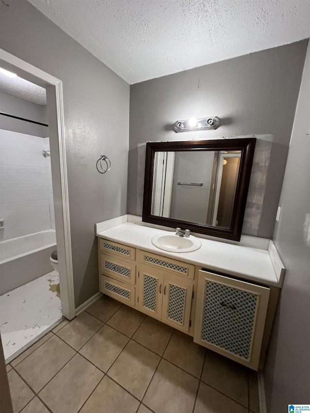 bathroom featuring tile patterned floors, vanity, shower / bath combination, and a textured ceiling