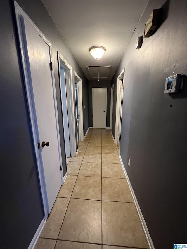 hall featuring light tile patterned flooring