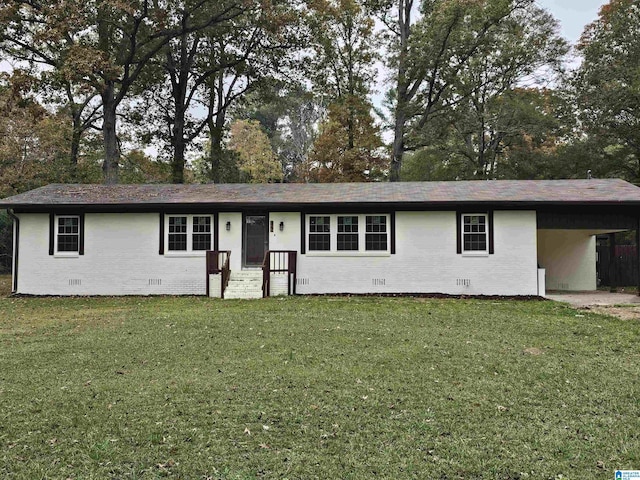 ranch-style home with a front yard and a carport