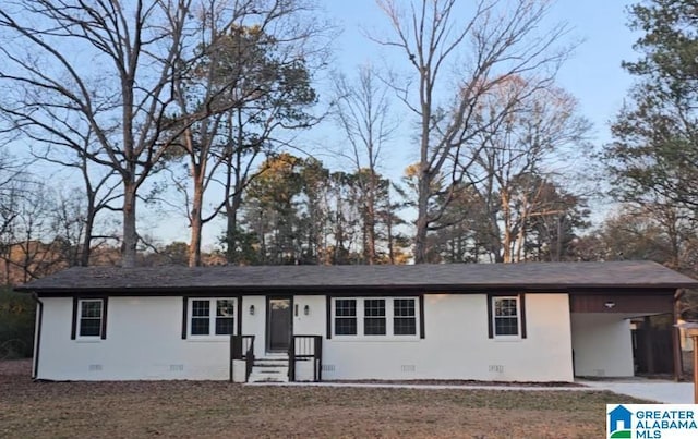 ranch-style home with a carport