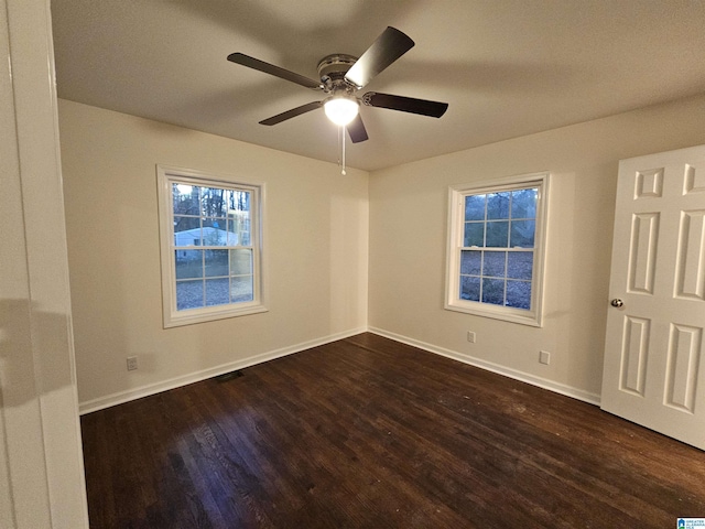 empty room featuring ceiling fan and dark hardwood / wood-style floors