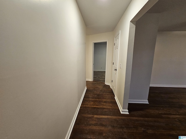 corridor featuring dark hardwood / wood-style floors