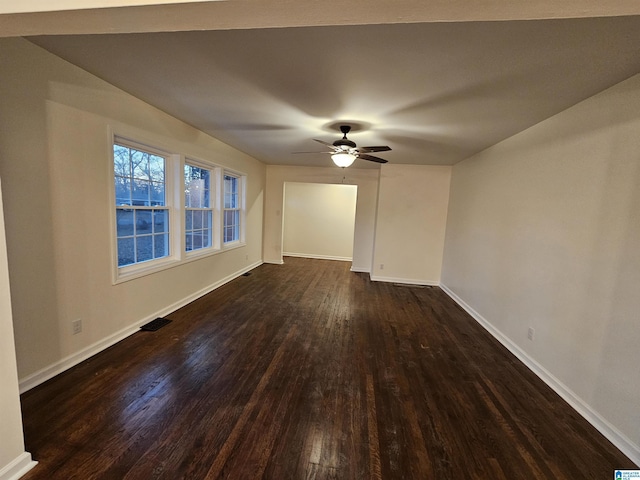 spare room with dark hardwood / wood-style flooring and ceiling fan