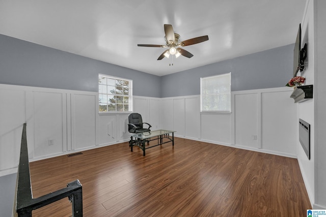 living area with ceiling fan and hardwood / wood-style floors