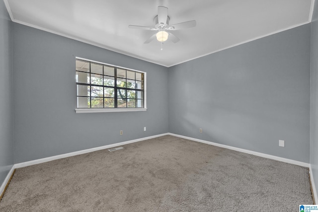 carpeted empty room featuring ceiling fan and ornamental molding