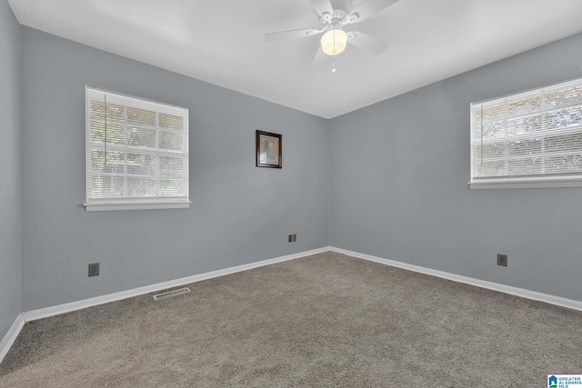 carpeted spare room with ceiling fan