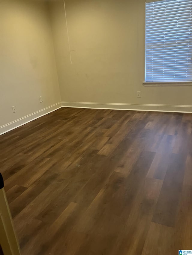 empty room with dark wood-type flooring