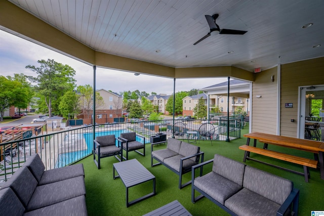 view of patio with an outdoor living space, ceiling fan, and a fenced in pool