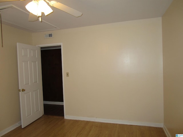 empty room featuring hardwood / wood-style floors and ceiling fan