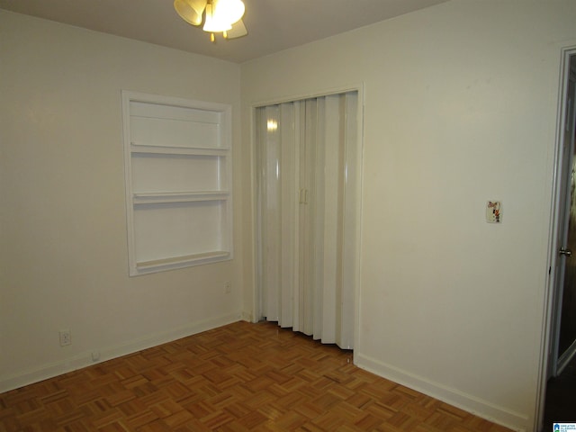 unfurnished bedroom with parquet flooring and ceiling fan