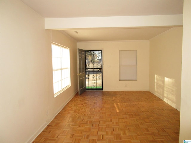 empty room featuring light parquet floors and a healthy amount of sunlight