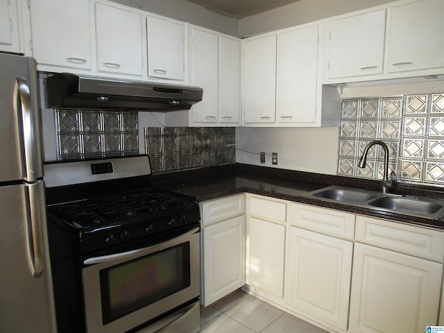 kitchen with white cabinetry, sink, backsplash, light tile patterned floors, and appliances with stainless steel finishes