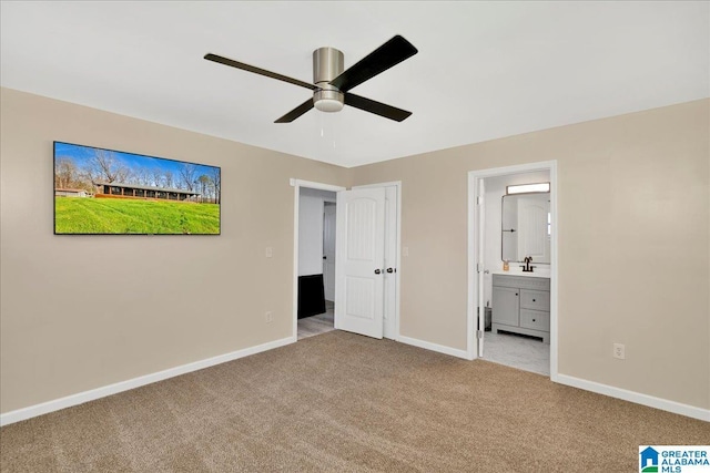 unfurnished bedroom with ensuite bath, ceiling fan, sink, and light colored carpet