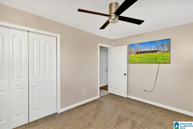 unfurnished bedroom featuring ceiling fan, a closet, and carpet