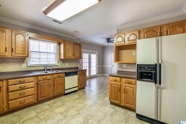 kitchen featuring tasteful backsplash, ornamental molding, white appliances, ceiling fan, and sink