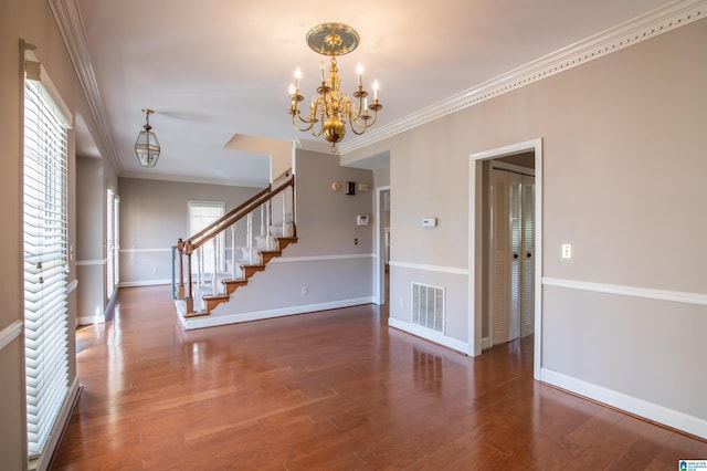 interior space featuring hardwood / wood-style floors, a chandelier, and ornamental molding