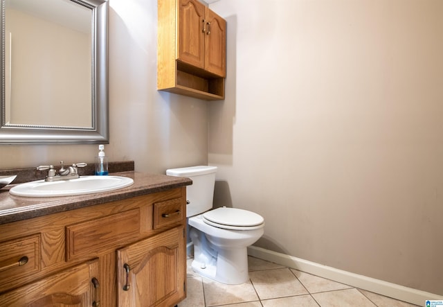 bathroom featuring tile patterned flooring, vanity, and toilet