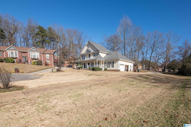 view of side of property with a porch and a yard